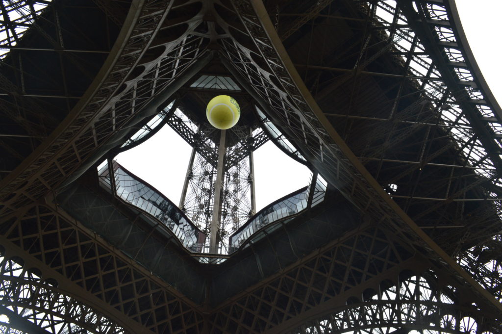 Queueing underneath the Eiffel Tower - spot the Roland Garros ball!